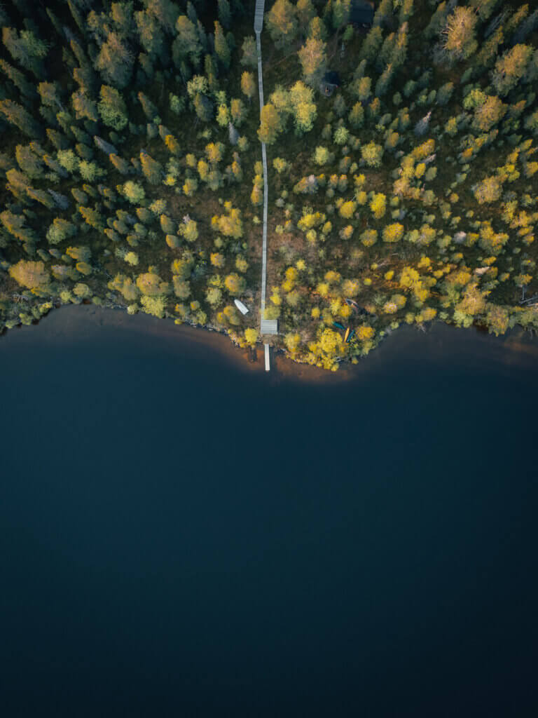 Aerial view of a remote lake and forest in Finnish Lapland wilderness